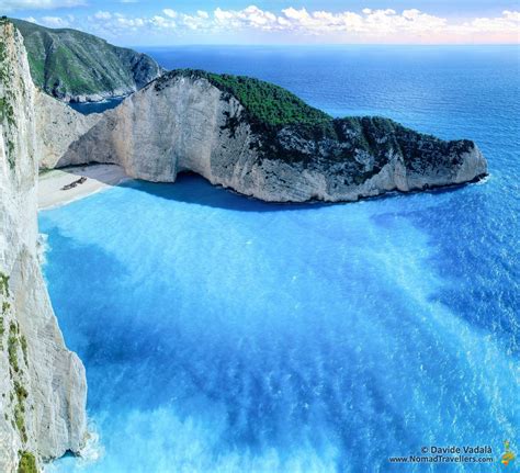 The Intense Blue Water Of The Shipwreck Cove Zakynthos Greece Beach