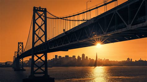 Download San Francisco Skyline With Sunset Bridge Wallpaper