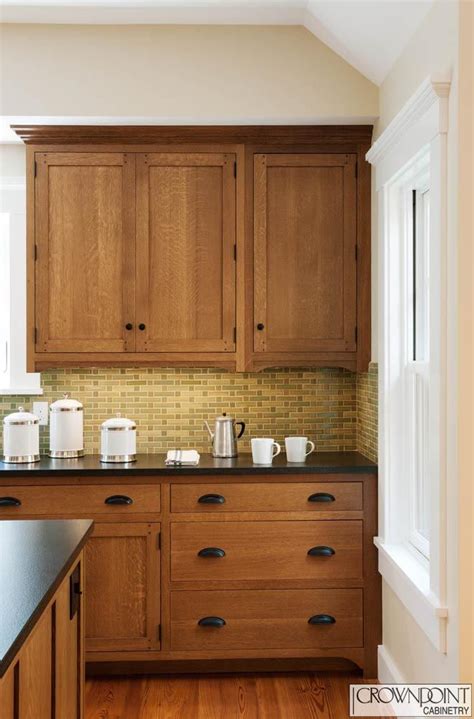 Provide a nailing surface for crown moulding by attaching solid wood mounting strips to the top edges of the cabinets. © Crown Point Cabinetry | Lake house kitchen, Craftsman style kitchens, Custom kitchen cabinets