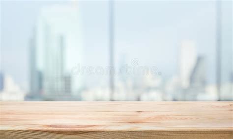 Wood Table Top On Blur Window Glasswall Background With City Viewfor