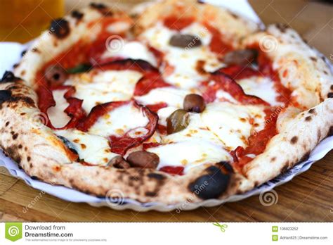 Delicious Italian Pizza With Mozzarella Salami And Olives On Wooden