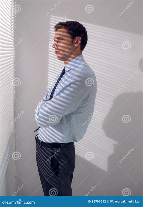 Businessman Peeking Through Blinds In Office Stock Photo Image Of