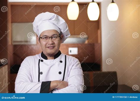 Portrait Of Happy Proud Asian Chef Smiling At Camera With Crossed Arms