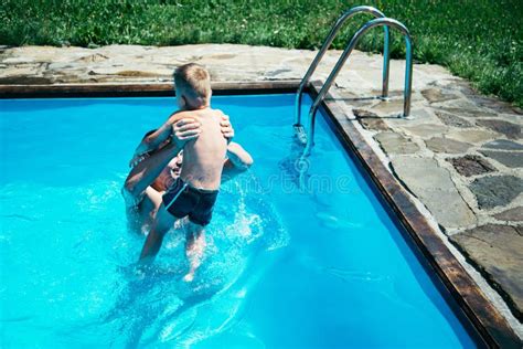 Father And His Son Having Fun In The Swimming Pool Stock Image Image