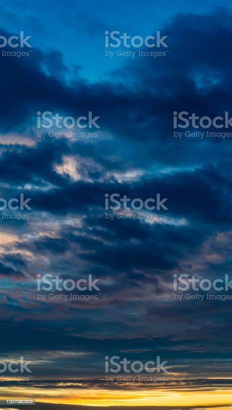Fantastic Clouds At Sunrise Vertical Panorama Stock Photo Download