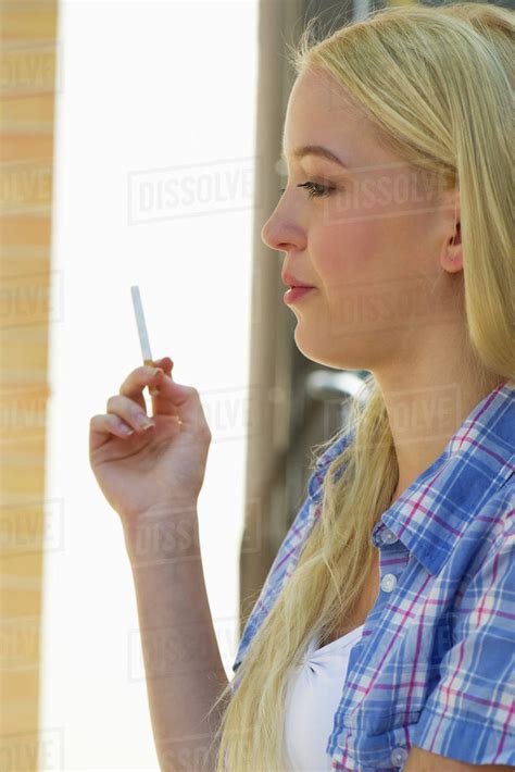 Young Woman Smoking Cigarette Stock Photo Dissolve