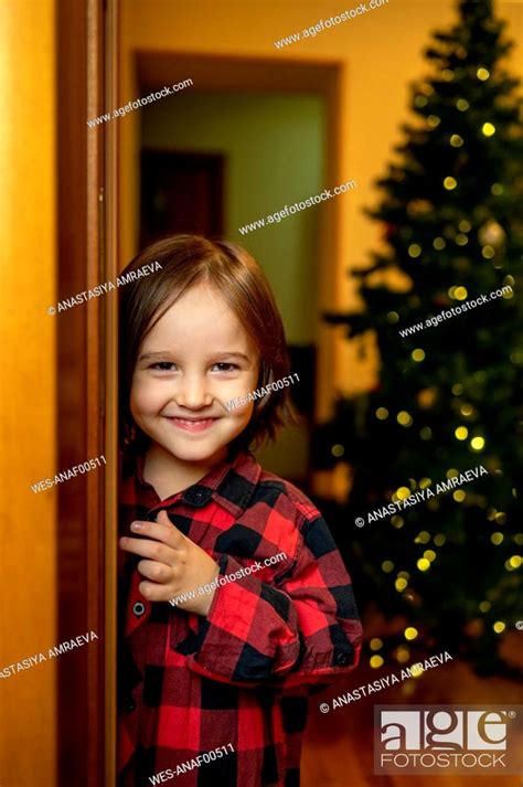 Smiling Boy Standing Near Doorway At Home Stock Photo Picture And