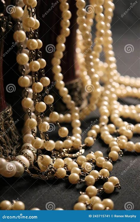 Pearl Necklaces Spilling From Burgundy Decorative Containers Stock