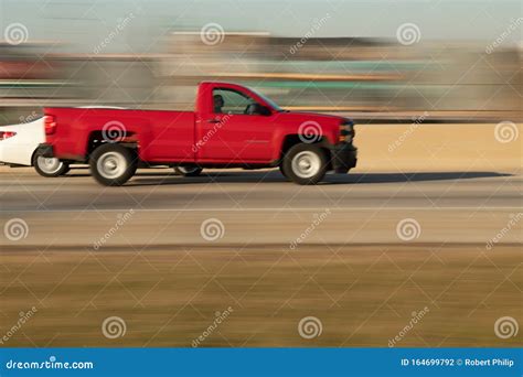A Red Pickup Truck Speeds Down The Expressway Editorial Photography