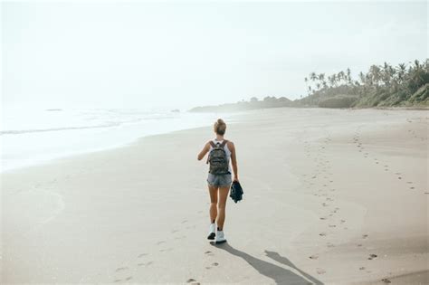 Free Photo Young Beautiful Girl Posing On The Beach Ocean Waves Bright Sun And Tanned Skin