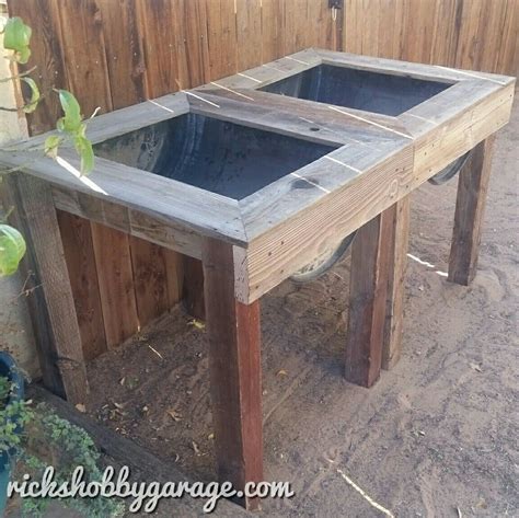 Raised Planters Made With Plastic 55 Gallon Drum And Reclaimed Wood