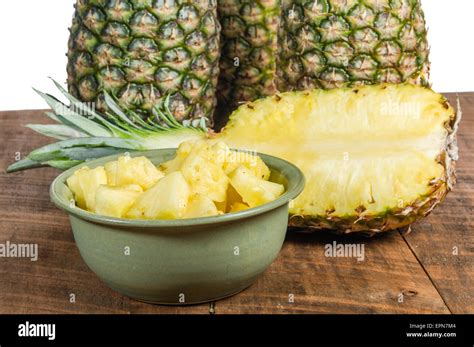 Pineapples With Bowl Of Fresh Cut Pineapple Fruit Stock Photo Alamy