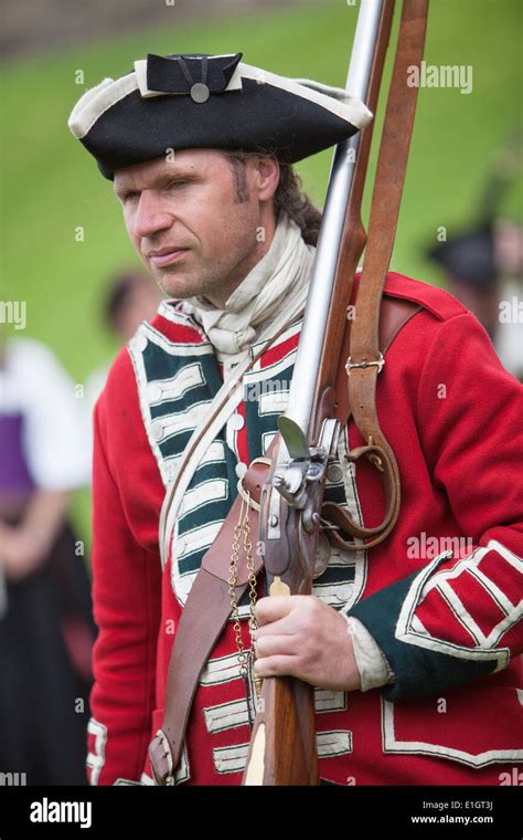A Soldier Dressed In Traditional 17th Century English Army Redcoat