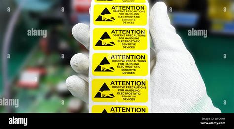 Hand Holding Esd Symbol Label With Antistatic Gloveselectrostatic