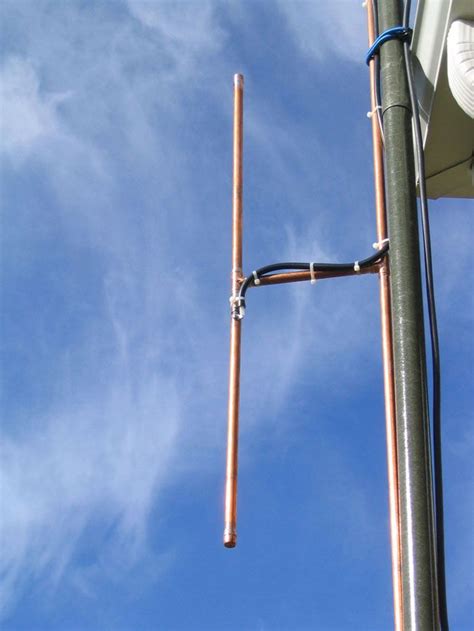 A Street Light With Two Poles Attached To Its Side And Blue Sky In The