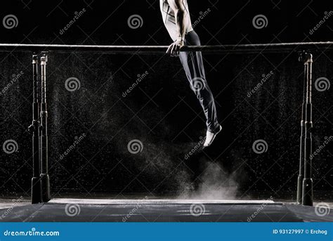 Male Athlete Performing Handstand On Gymnastic Parallel Bars With