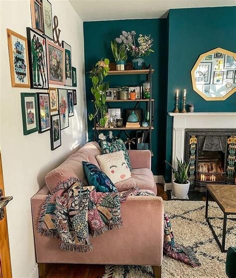 A Living Room With A Pink Couch And Lots Of Pictures On The Wall Above It