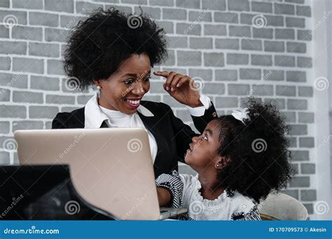 African American Business Woman Taking Care Of Her Little Daughter