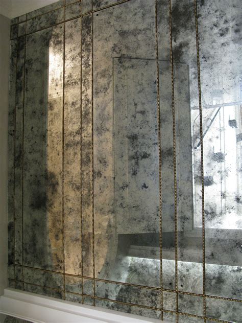 The faded beauty of antiqued mirror tiles softens the crisp look of a standard mirror. Antique mirror produced by Sterling Studios | Antique ...