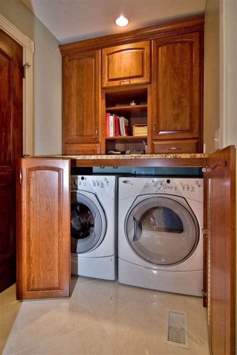 A stacked washer and dryer are hidden behind blue lattice doors located under stacked blue upper cabinet s in a beautiful blue laundry room. Good way to hide the washer and dryer! | Kitchen | Pinterest