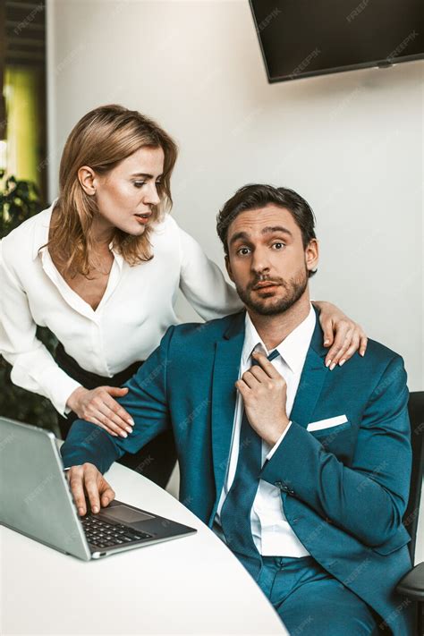 Premium Photo Flirtation Or Sexual Harassment Blonde Woman Seduces Man Working With Laptop