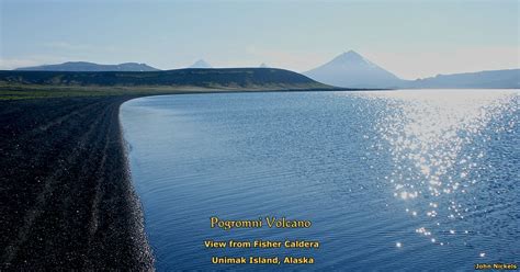 Alaska is home to more than 40 active volcanoes, many of which have erupted violently and repeatedly in the last 200 years. Pogromni Volcano as seen from lake in Fisher Caldera ...