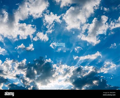 Dramatic Sky With Clouds Streaming Sunlight Stock Photo Alamy