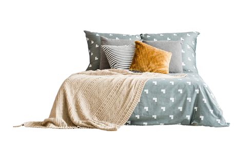 Bed With Blue Bed Sheets Pillows And Beige Blanket Isolated On A