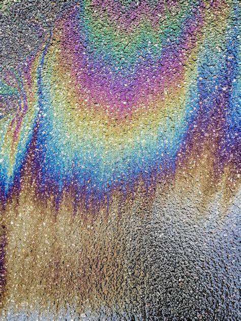 Multi Colored Oil Spill On Asphalt Road Abstract Background Stock