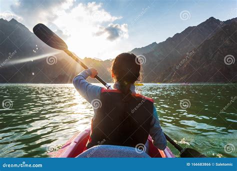 Woman Kayaking In A Lake At Sunset Stock Photo Image Of Floating