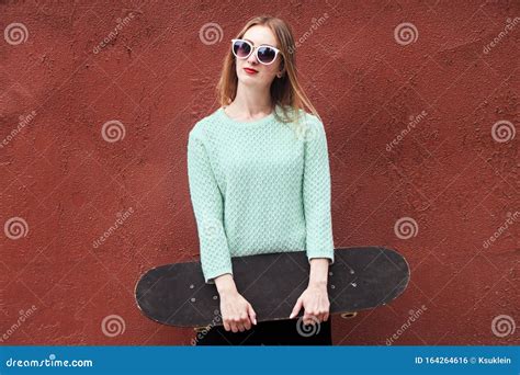 Fashion Woman With A Skateboard Girl In Sunglasses With Longboard