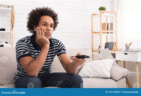 Bored Arican American Teen Watching Tv At Home Stock Image Image Of