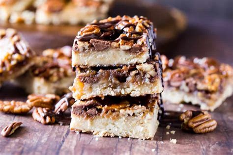 These pecan pie bars are sweet, crunchy, gooey, loaded with pecans, an easy shortbread crust and perfect for a crowd! Chocolate Pecan Pie Bars - The Seaside Baker