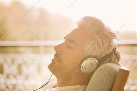 Serene Man With Headphones On Sunny Patio Stock Image F0174655