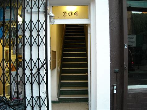 Stairs | Next to pile of trash, open door with stairs | Adam P. Knave