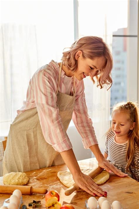 Girl Enjoys Making Cake With Mom In The Kitchen Stock Image Image Of Apron Female