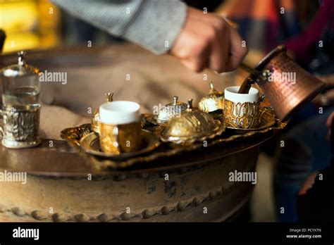 Serving Turkish Coffee Which Cooked In Hot Sand From A Copper Cezve To