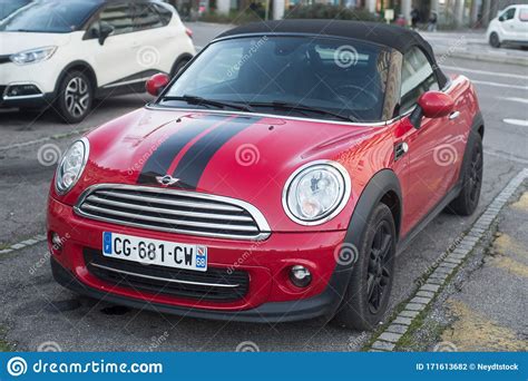 Front View Of Red Mini Cooper Convertible Parked In The Street