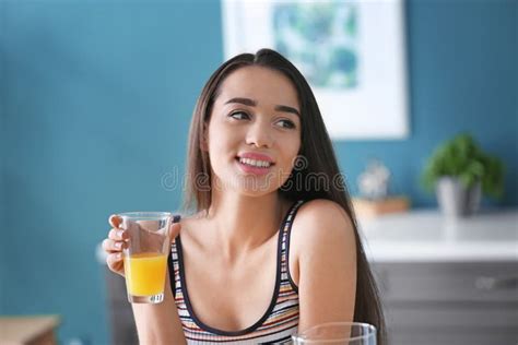 Young Woman With Glass Of Fresh Orange Juice At Home Stock Image