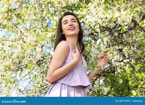 Beautiful Young Woman Near Blossoming Tree On Sunny Spring Day Stock