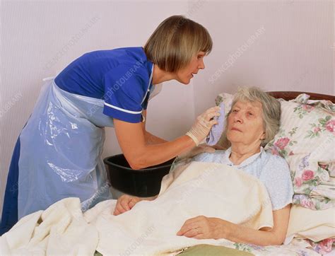 District Nurse Gives Elderly Patient A Bed Bath Stock Image M340