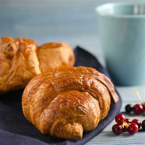 Fresh Ruddy Croissants With Berries Lie On A Wooden Table Next To Fresh