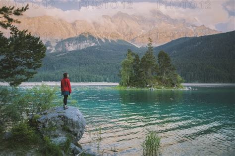 Germany Bavaria Eibsee Young Woman Standing On Rock By Eibsee Lake