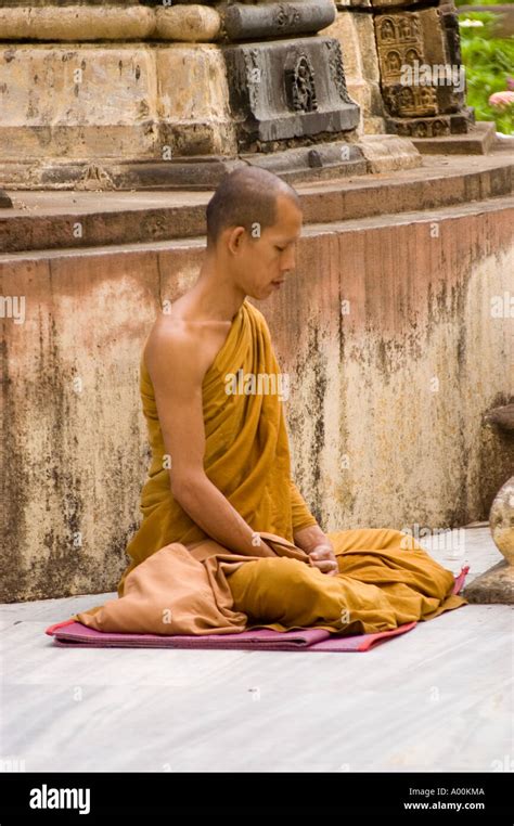 Theravada Monk Meditating Under Stupa At Mahabodhi Mahavihara Temple
