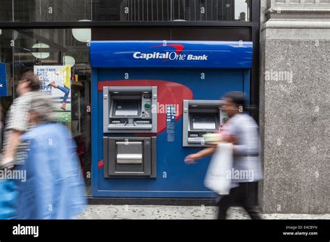 Pedestrians Walk By A Capital One Bank Atm In The New York City Borough