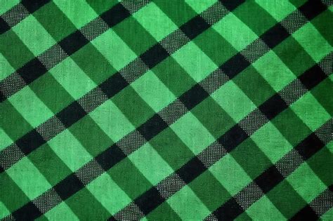 Premium Ai Image A Green And Black Plaid Fabric With A Black Stripe