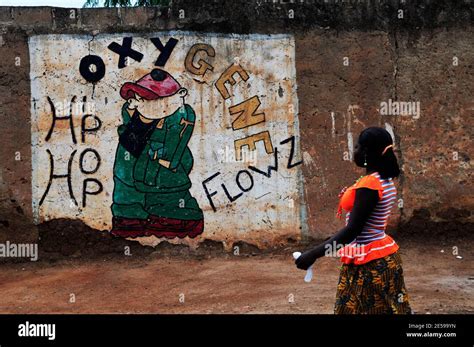 A Burkinabe Woman Walking By A Colorful Mural In Ouagadougou Burkina
