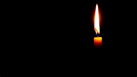 A Single Candle Burning In The Dark Free Stock Video