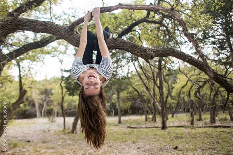 A Woman Hanging Upside Down From A Tree Branch High Res Stock Photo My Xxx Hot Girl