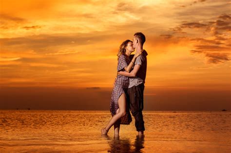 拥抱着站在海中的年轻情侣图片 黄昏时拥抱着站在海中的年轻情侣素材 高清图片 摄影照片 寻图免费打包下载